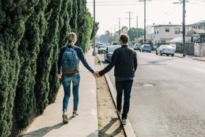 couple holding hands walking