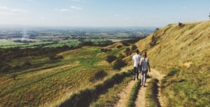 couple hiking through fields