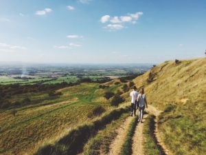 couple walking through fields