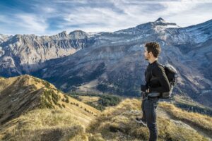 man looking out at scenic mountain landscape